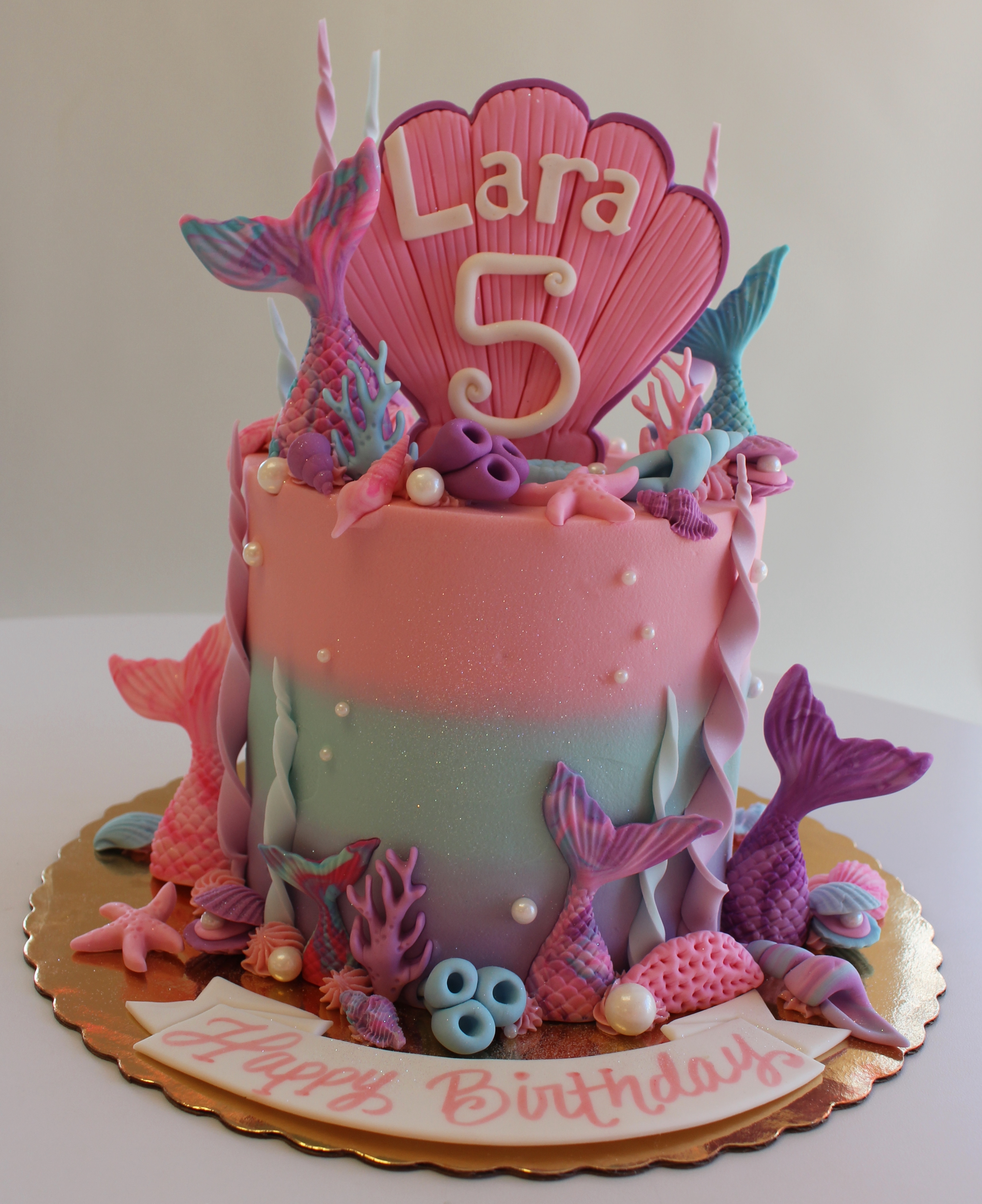 Pink Teal and Purple Mermaid Themed Birthday Cake with Fondant Mermaid Tails Decorations and Clam Shell Topper